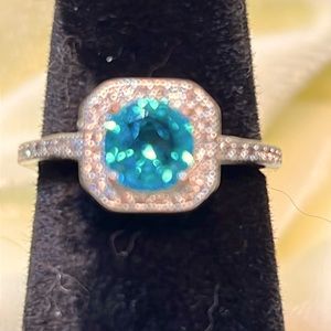 Silver ring with blue center stone and small white accent stones. S925. Size 7